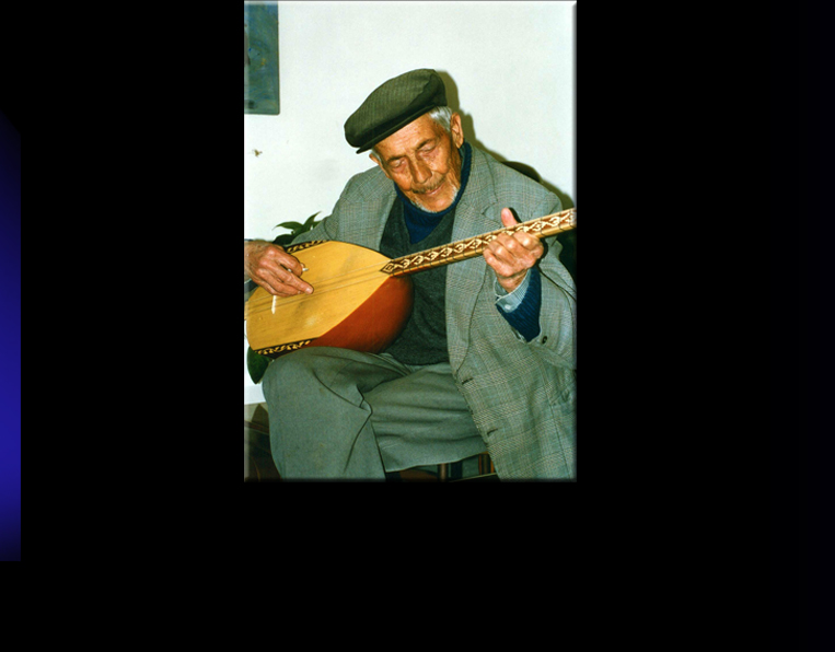 Man from Uchisar playing Saz, the traditional stringed instrument.