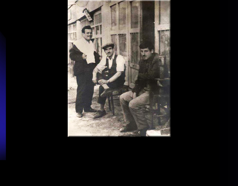 Men in front of Uchisar's former Barber Shop. Photo from private collection of Mustafa Yedek, taken in the 1950th.